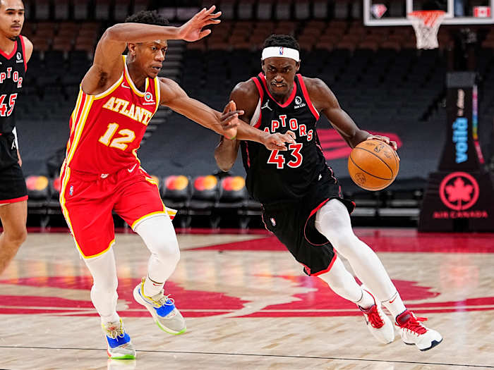 Toronto Raptors forward Pascal Siakam drives to the net against Atlanta Hawks forward De'Andre Hunter. The Hawks and Raptors play each other three times in the 2022-23 NBA season.